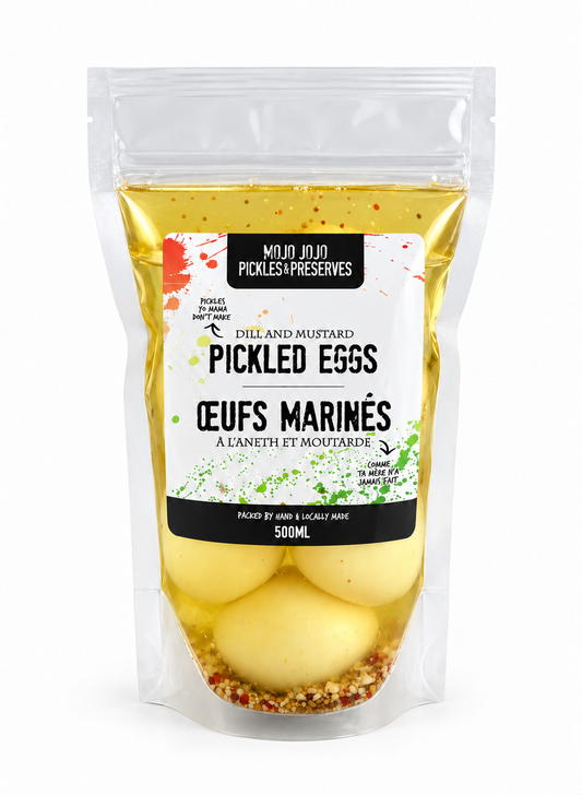 A 500ml stand-up pouch of Mujo Jujn Pickles & Preserves Pickled Eggs (Céufs Marinés) filled with yellow mustard and spices, containing four pale eggs at the bottom.